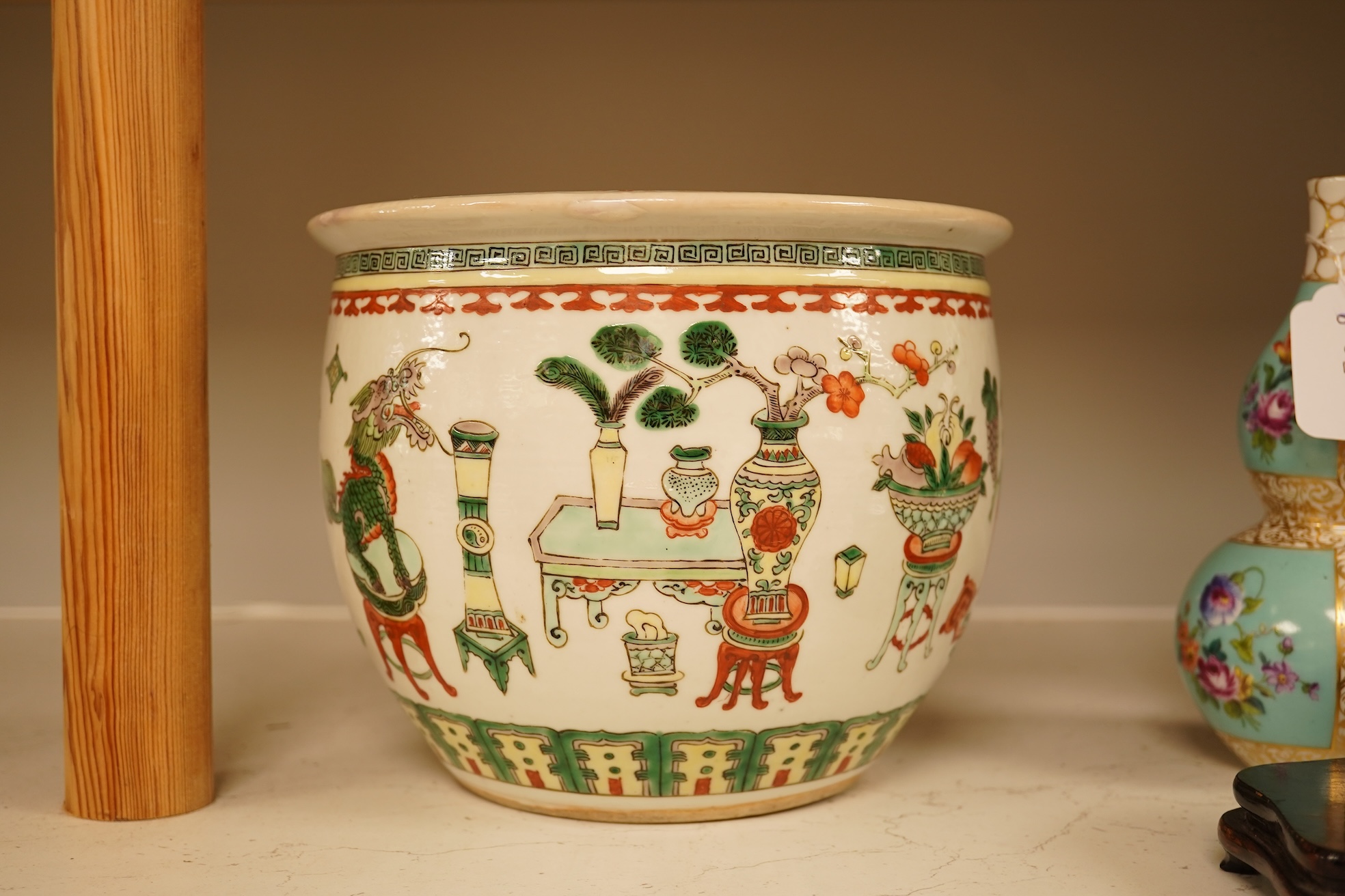 A Chinese Hundred Antiques famille verte small jardiniere, 19th century, 17cm high, 21cm diameter.